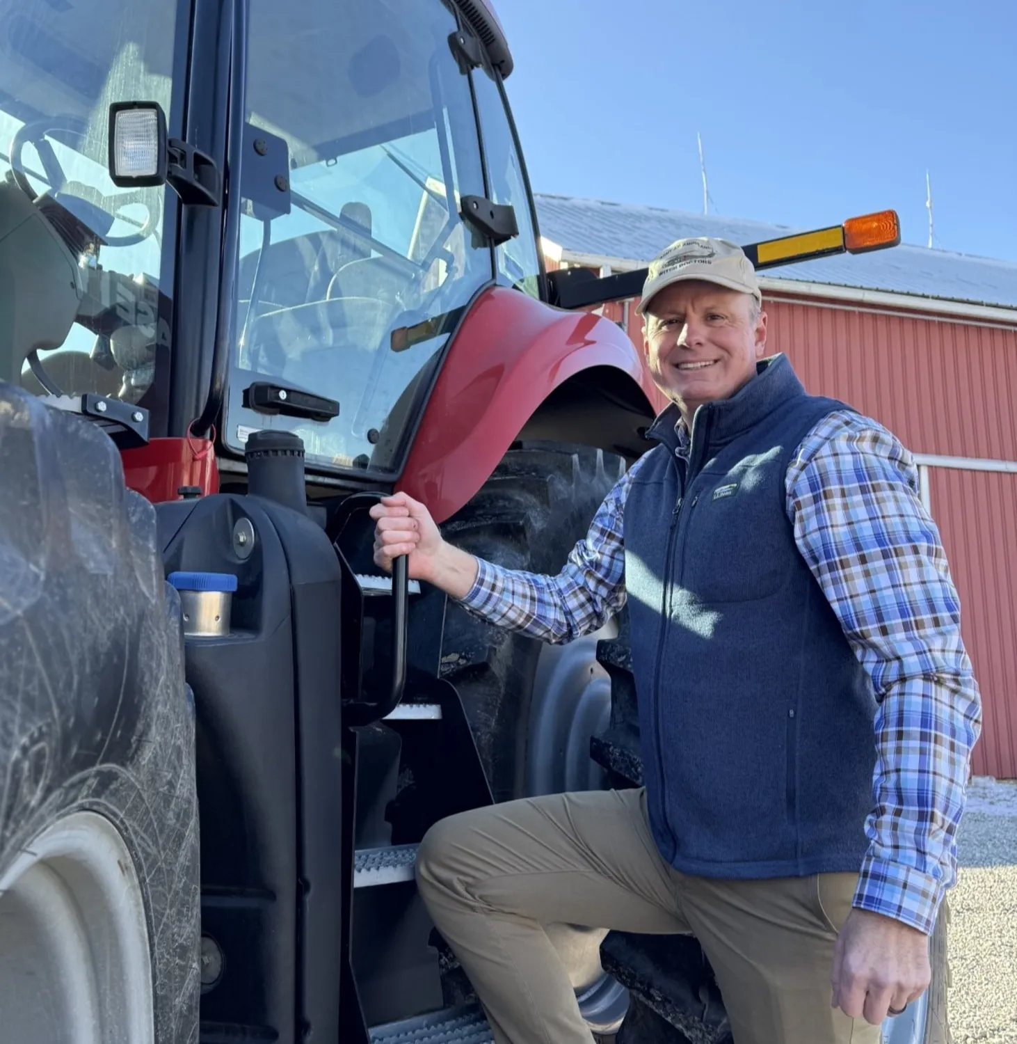 Shaun Bailey beside his tractor on the family farm