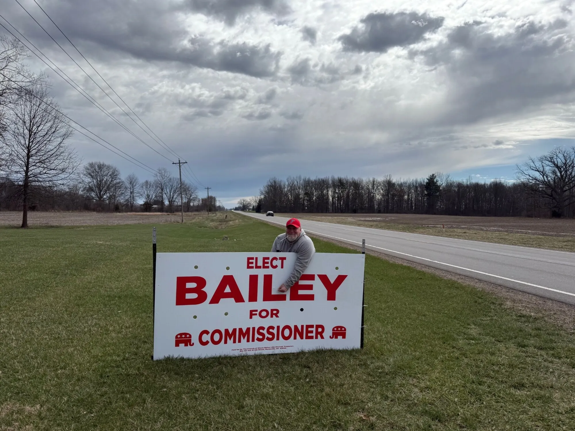 Campaign sign being installed by volunteers